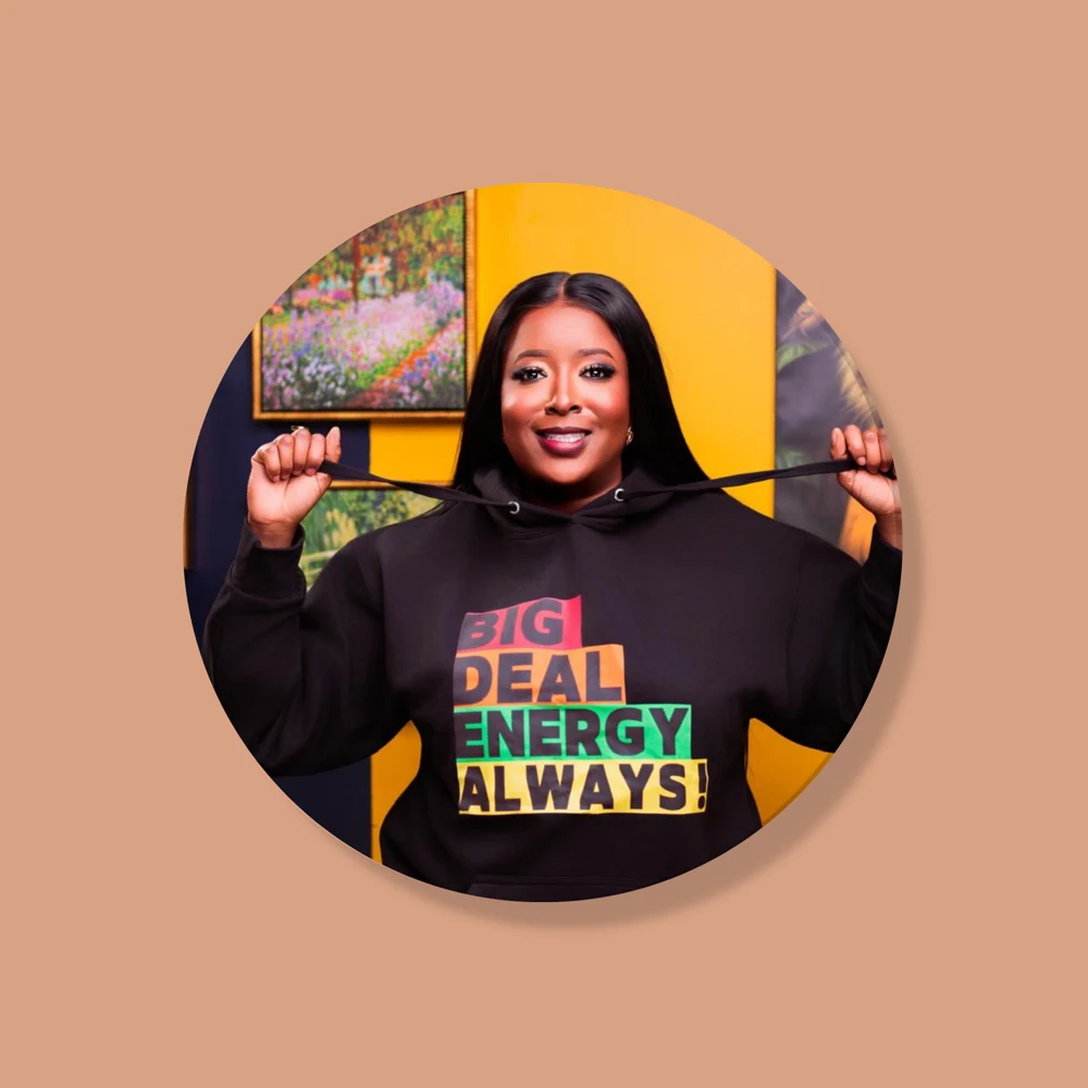Symonette Hibbert smiling in a Big Deal Energy Always hoodie